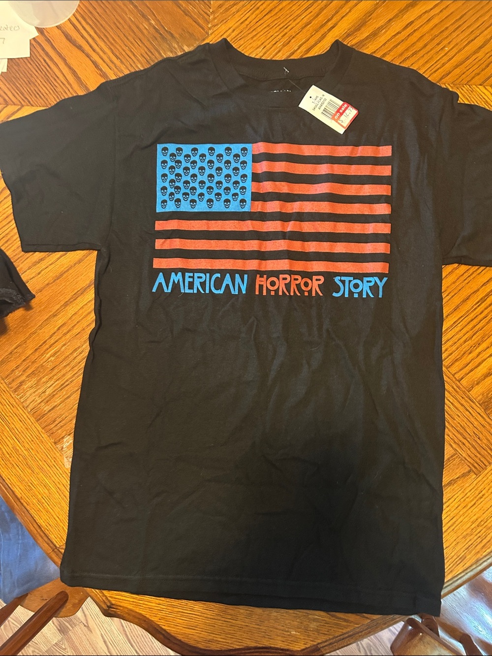 Black Graphic Short-Sleeve Tee with Blue and Red Flag Design